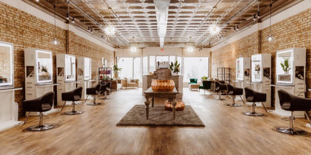 Alia Rose standing outside her salon in Westmont Illinois next to the storefront
