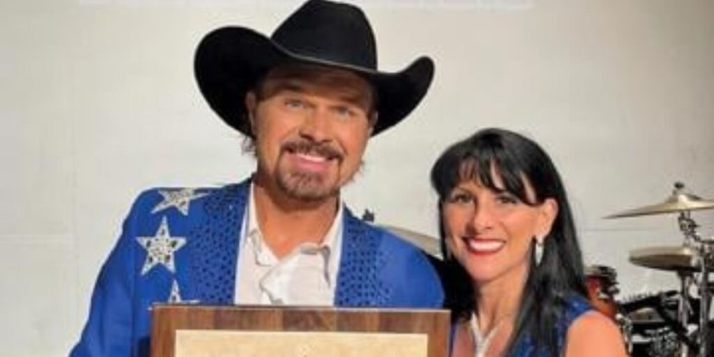 Clay Cooper smiling with his wife Tina Cooper at the Clay Cooper Theatre in Branson, Missouri