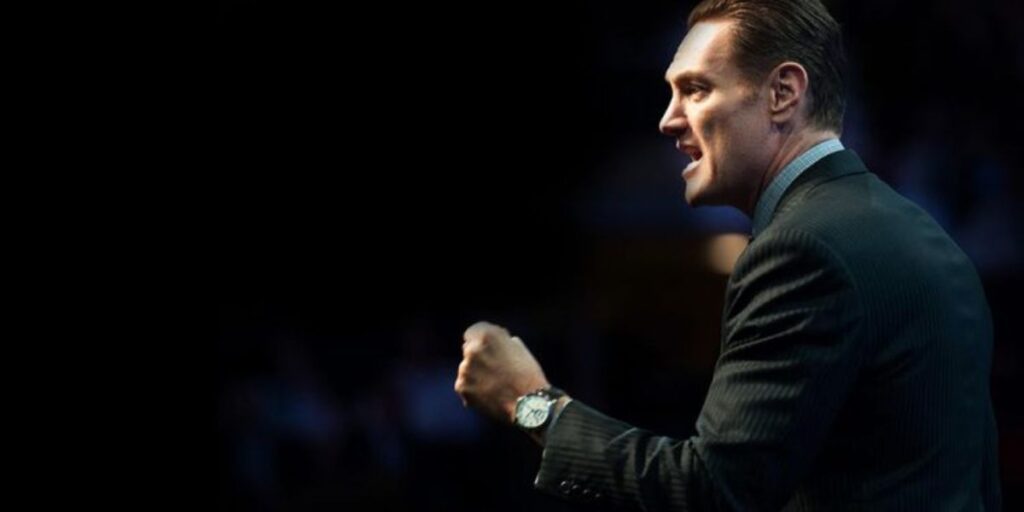 “Darren Hardy delivering a motivational speech on success and personal development”