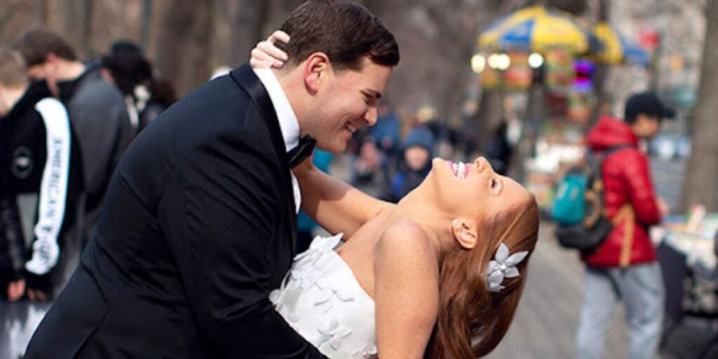 Jackie Oshry with her husband Zachary Weinreb smiling together at an event