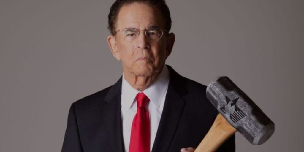 Jim Adler holding a hammer symbolizing “The Texas Hammer” persona