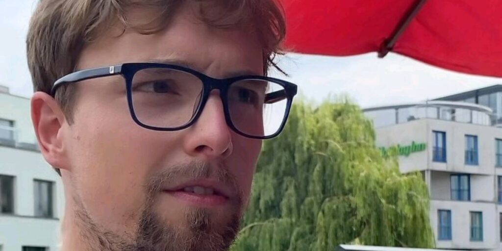 Jimmy NoCap smiling in a casual outfit with a relaxed and friendly expression
