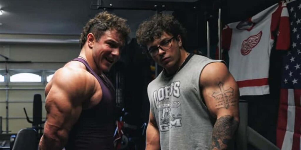 Tren Twins Christian and Michael Gaiera posing in the gym with muscular physiques
