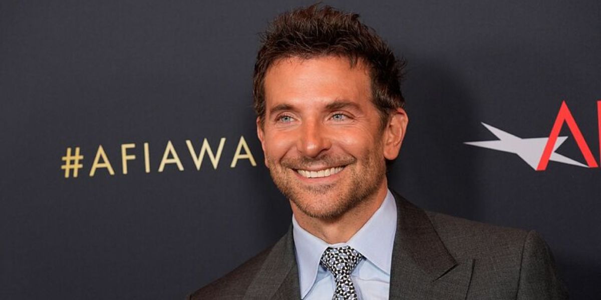 Bradley Cooper smiling in a casual outfit with friendly expression