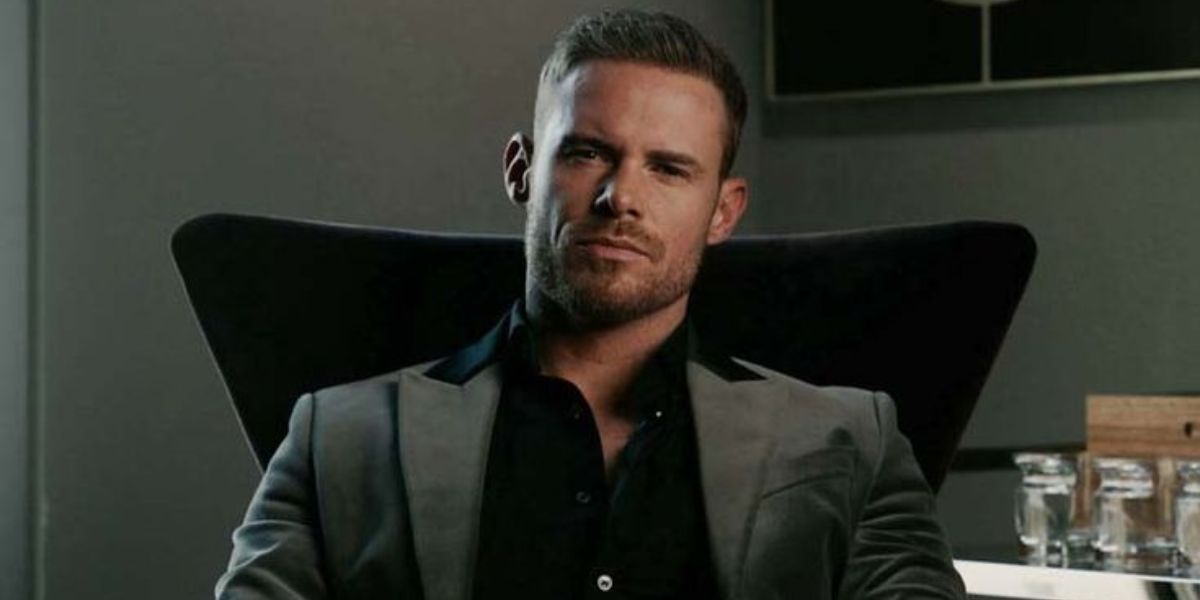 Justin Waller standing in front of a construction site with RedIron Construction equipment in the background